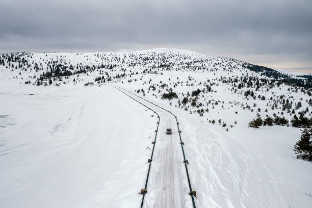 istock A snowy mountain with a car on the road 1467823629
