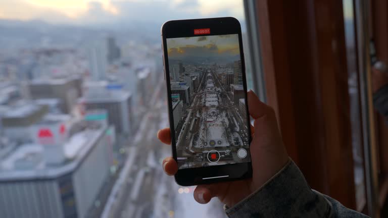 Women shooting a Sapporo cityscape video from TV tower