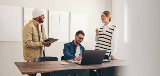 istock Happy business colleagues working together in a creative office 1467823976
