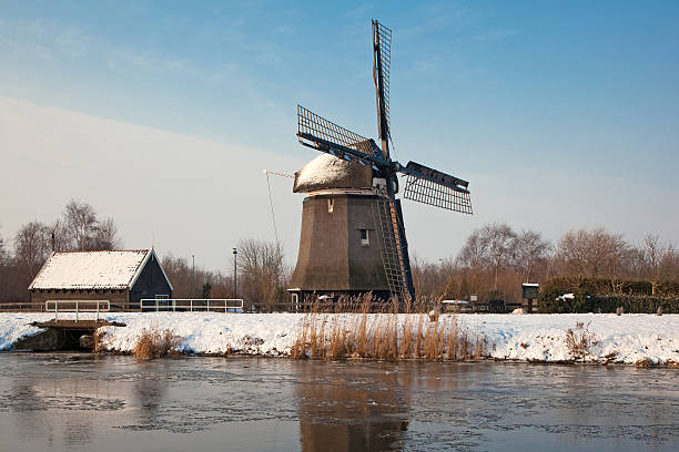 istock Dutch windmill in winter landscape 146782447