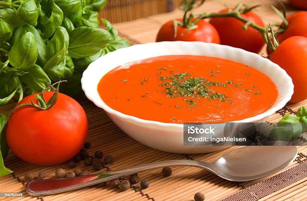 Tomato soup Tomato soup in a bowl with healthy and fresh ingredients and herbs Tomato Soup Stock Photo