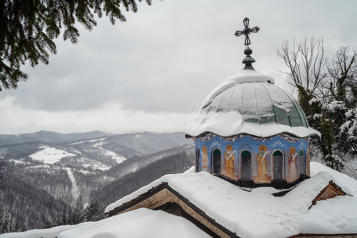 Picturesque winter landscape with the beautiful snow-covered dome of Sokolski Monastery near Gabrovo, Bulgaria