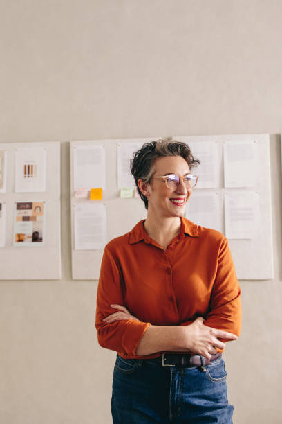 istock Interior designer looking away with a happy smile in her office 1467824582