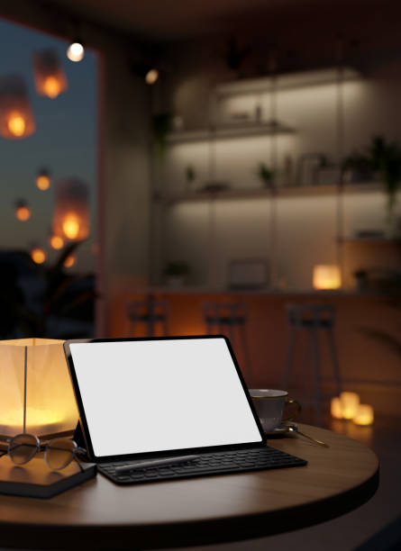 istock Tablet mockup with wireless keyboard on table in modern dark co-working space at night. 1467826292