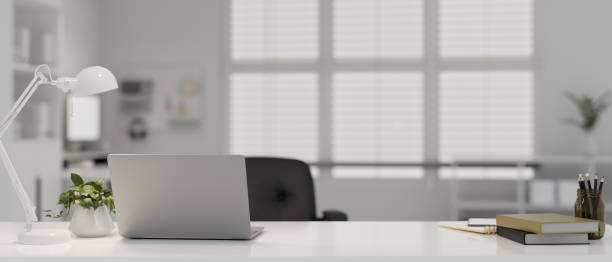 istock Modern doctor office with laptop, table lamp, stationery and decor on table. doctor's office 1467826302