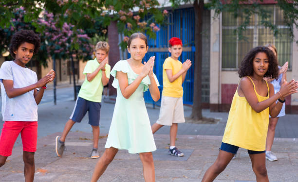 istock Modern cheerful tweenagers performing street dance choreography 1467826360