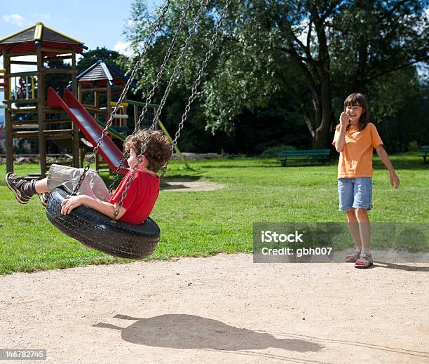 Kids Having Fun In Playground Stock Photo - Download Image Now - 14-15 Years, Playground, Swing - Play Equipment