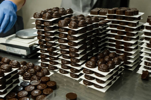 istock Chocolate candy making. Chocolates in gift box, various luxury pralines 1467828444