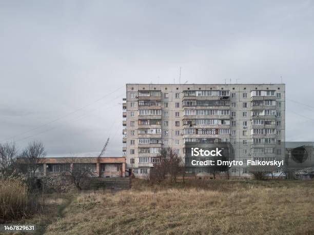 Gloomy Cloudy Cityscape With Old Gray Concrete Soviet Prefabricated Ninestorey Panel Apartment Building Stock Photo - Download Image Now