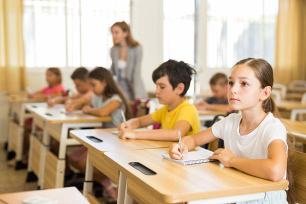 istock Schoolkids sitting at desks 1467829937