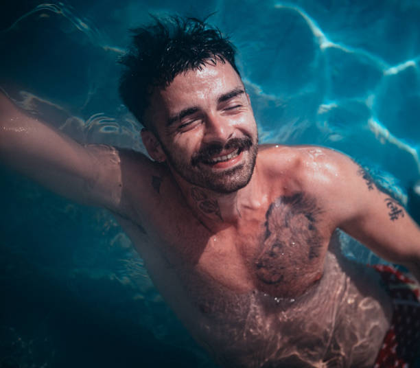 istock Young man on vacation in the pool 1467831314