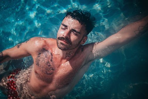 Portrait of a mid adult man in the pool at hotel