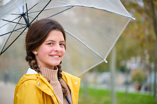 young woman standing under an umbrella transparent