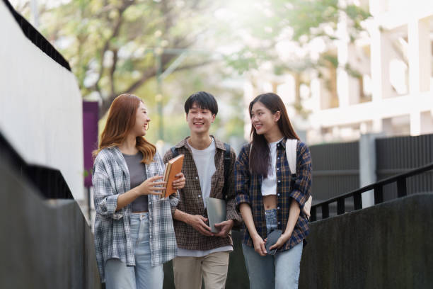 istock Group of Young Asian student walking and talking at university before class room. education, back to school concept 1467835098