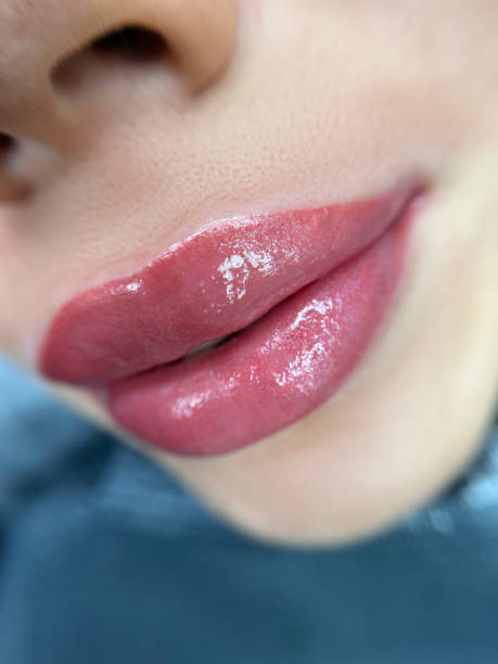 istock permanent sexy wowans lips tattoo close up, lipstick effect make up 1467835228