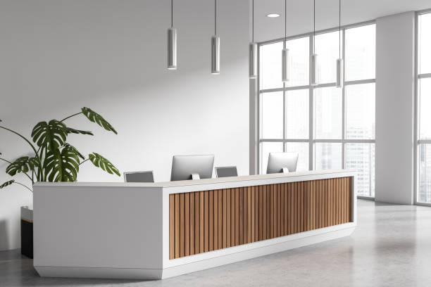 istock Corner view on bright office room interior with desktops 1467837263