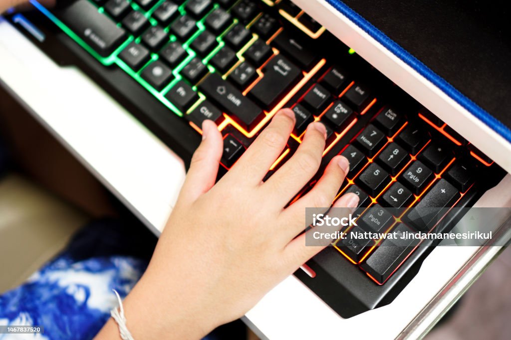 A Closeup Picture Shows A Student Using A Desktop Computer Keyboard To ...