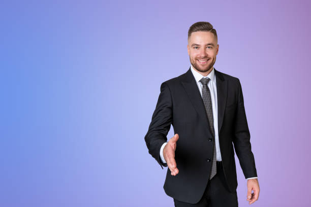 istock Smiling businessman stretching out hand to shake, copy space gradient background 1467837650