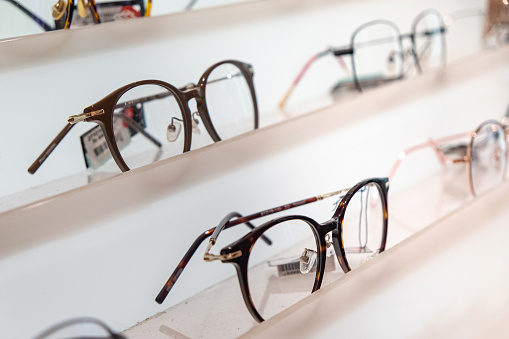 Close-up shot of variation eyeglasses on retail display eyewear store
