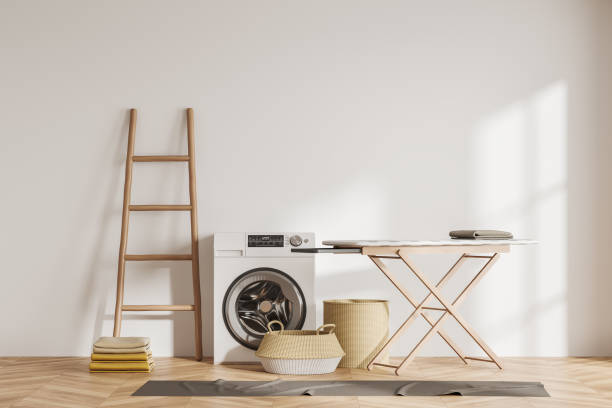 istock Laundry interior with washing machine and ironing board. Mock up empty wall 1467840082