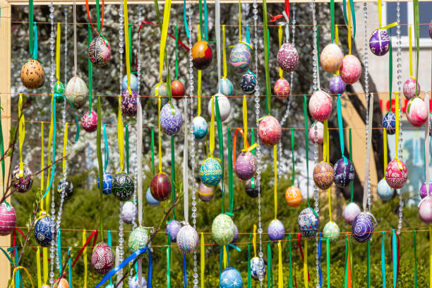 istock Painted eggs hang from the branches of the Easter tree. The focus is on a yellow egg painted by children by hand. 1467840182
