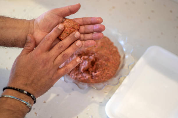 istock Man hands preparing meatballs with raw mincemeat 1467843389
