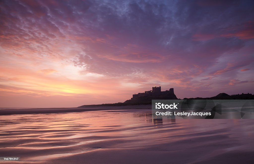 Bamburgh Castle and sands Bamburgh Castle, Northumberland, shot over Bamburgh Beach at sunrise Bamburgh Castle Stock Photo