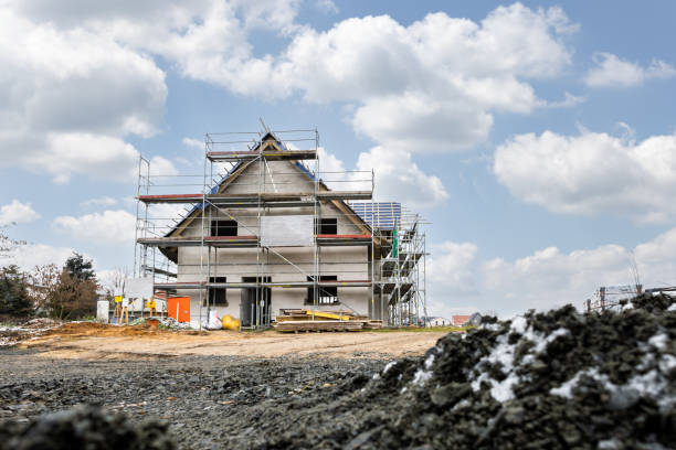 Exterior of a German family home under construction with scaffolding in winter time.