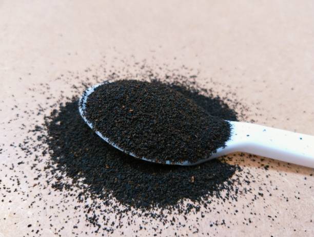 Black tea dust dried and grinded tea-leaves powder on spoon lose leaf tea-dust view cha preto image te negro dust photo stock photo