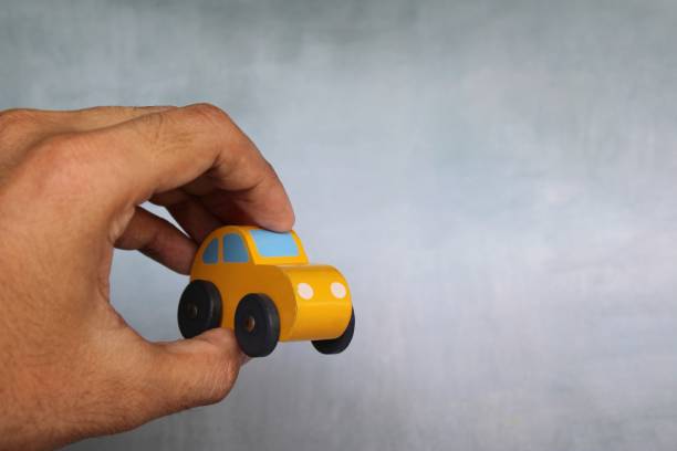 istock Closeup image of hand holding toy car with copy space 1467844202