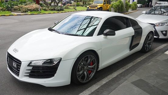 Surabaya, East Java, Indonesia - February, 2023 : elegant and luxurious sports car Audi R8 white color in the lobby