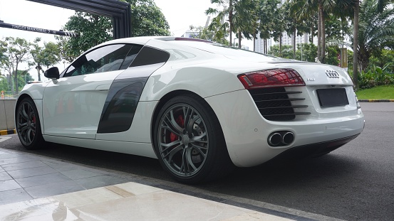 Surabaya, East Java, Indonesia - February, 2023 : elegant and luxurious sports car Audi R8 white color in the lobby