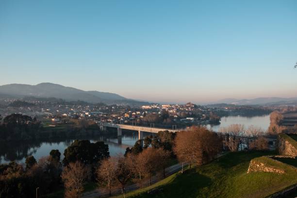 istock a small city with a river winding through it, situated near a picturesque bridge 1467847372