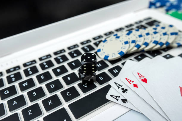 istock Online poker with laptop playing card chips and dice 1467847620