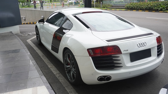 Surabaya, East Java, Indonesia - February, 2023 : elegant and luxurious sports car Audi R8 white color in the lobby