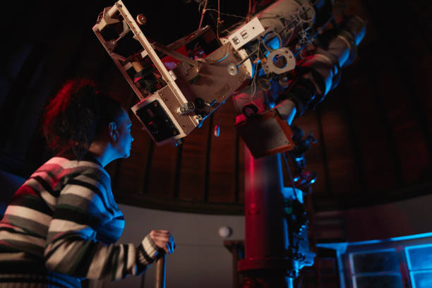 istock Astronomer with a big astronomical telescope in observatory doing science research of space and celestial objects. 1467853801