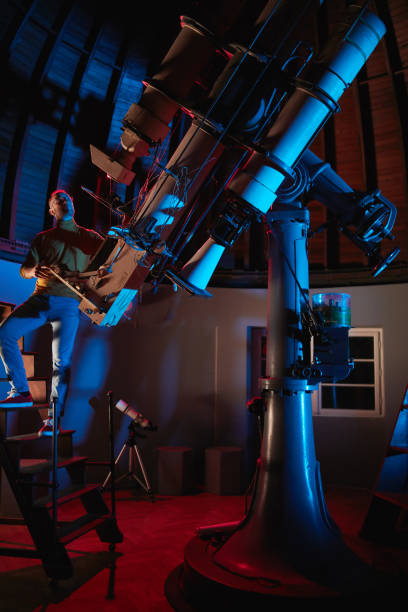 istock Astronomer with a big astronomical telescope in observatory doing science research of space and celestial objects. 1467853882