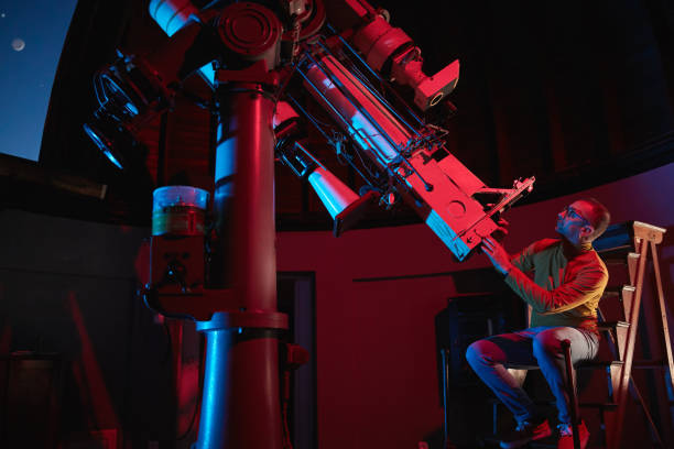 istock Astronomer with a big astronomical telescope in observatory doing science research of space and celestial objects. 1467853933