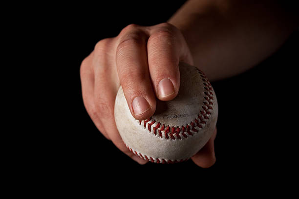 Man Gripping a Baseball - Curveball stock photo