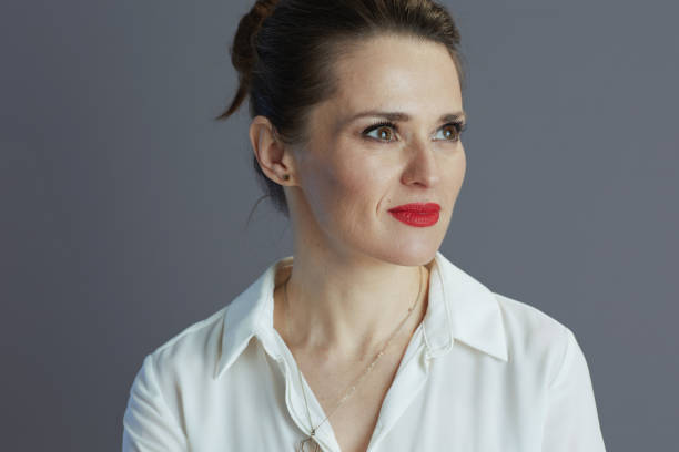 istock pensive business woman looking at copy space isolated on gray 1467859342