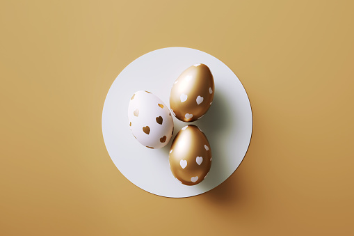 Gold painted Easter eggs on gold background. Horizontal composition with copy space. Easter concept.