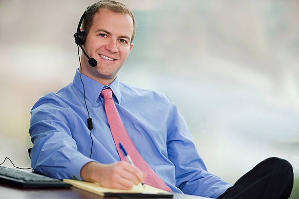 istock Young Business Man Sitting In Office Wearing Headset 146786141