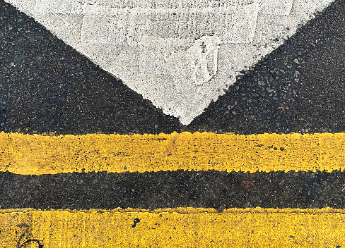 Close up of yellow and white road markings