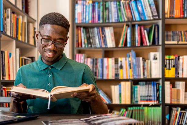 istock Young male student studying in the library 1467863775
