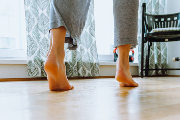 istock Walk barefoot on half toes on parquet floor 1467863957