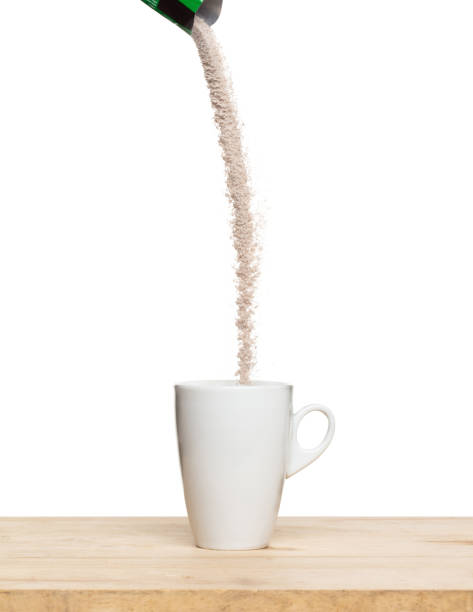 3 in 1 instant coffee powder mixed fly fall in cup, 3 in 1 instant coffee for fast easy float in air. 3 in 1 instant coffee throw in mid air. White background isolated high speed freeze motion