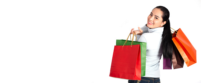 woman with a shopping bag on a white background ,Asian shopper smiling happy.