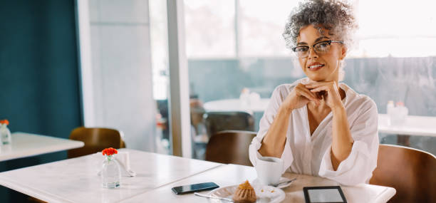 istock Cheerful businessswoman sitting in a cafe 1467866569