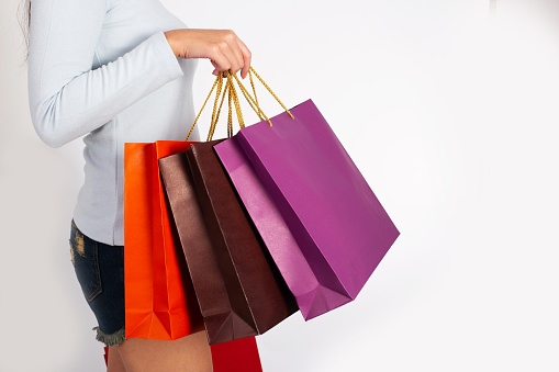 Attractive Beautiful asian woman holding shopping bag mockup on isolated white background.