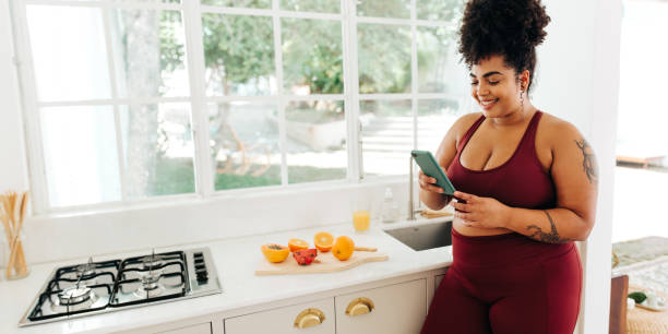 istock Plus size woman looking at smart phone 1467867448